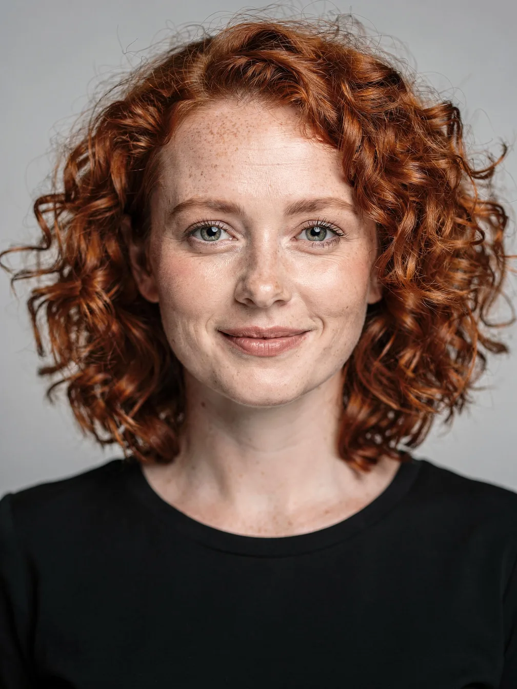 Head swap input: portrait of a woman with curly red hair (the head to use)