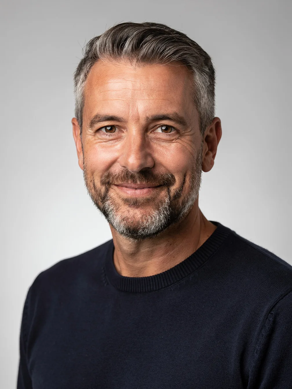 Head swap input: portrait of a man with salt-and-pepper hair and a short beard (the head to use)